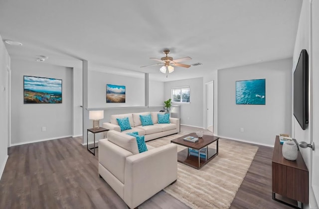 living room with wood-type flooring and ceiling fan