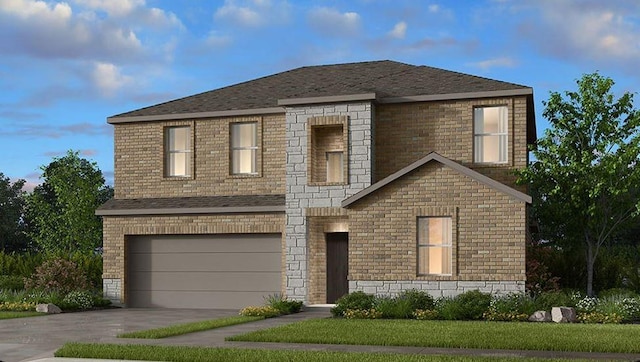 view of front of house featuring a garage and a front lawn