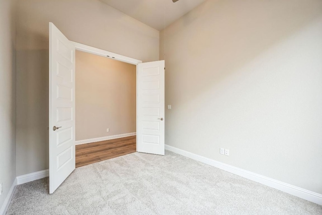 unfurnished bedroom with light colored carpet and baseboards