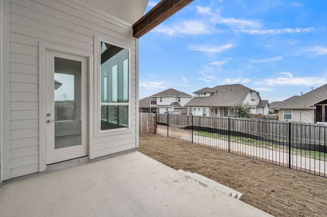 view of patio with a residential view and a fenced backyard