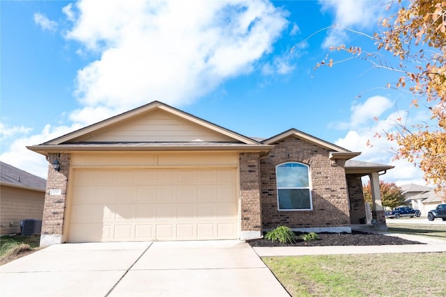 view of front of house with central AC unit and a garage