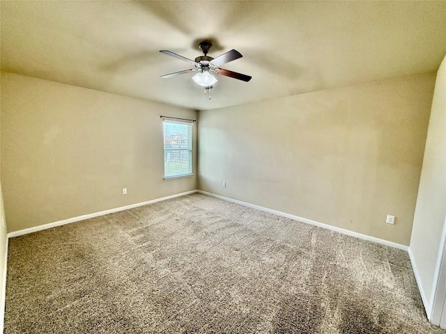 carpeted empty room featuring ceiling fan