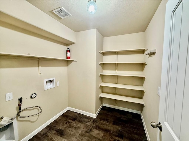 100 Wilson Ct, Hutto, TX 78634 - washroom featuring washer hookup, wood finished floors, and a textured ceiling