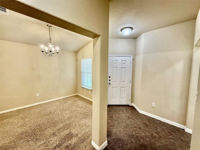 100 Wilson Ct, Hutto, TX 78634 - foyer with dark colored carpet, a chandelier, and vaulted ceiling