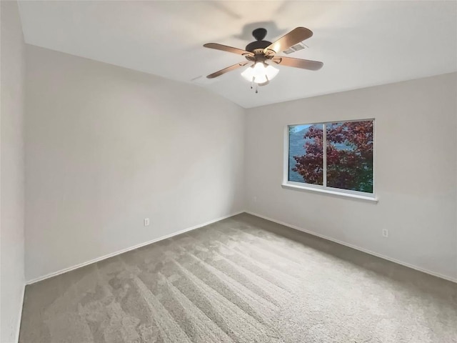 empty room featuring ceiling fan, carpet, and lofted ceiling