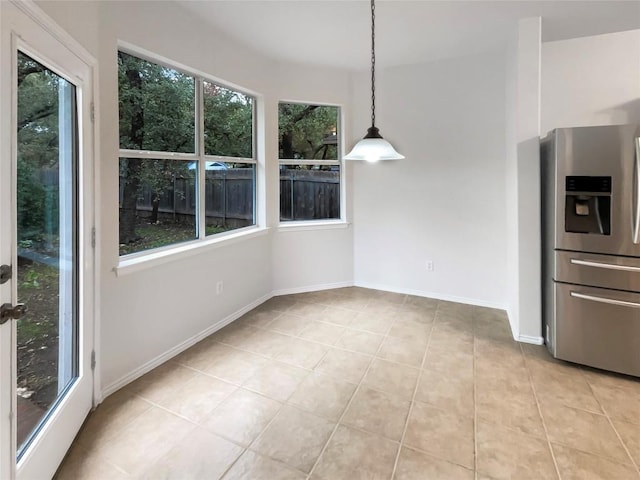 unfurnished dining area with light tile patterned floors