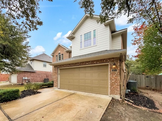 view of front of home with a garage and central AC