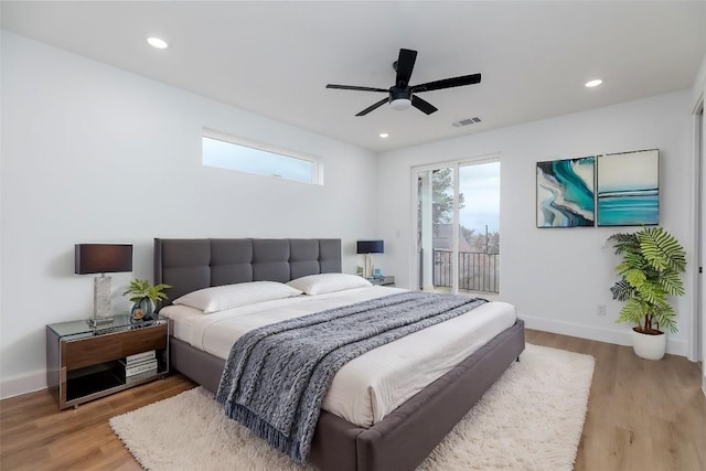 bedroom featuring access to exterior, light hardwood / wood-style flooring, and ceiling fan