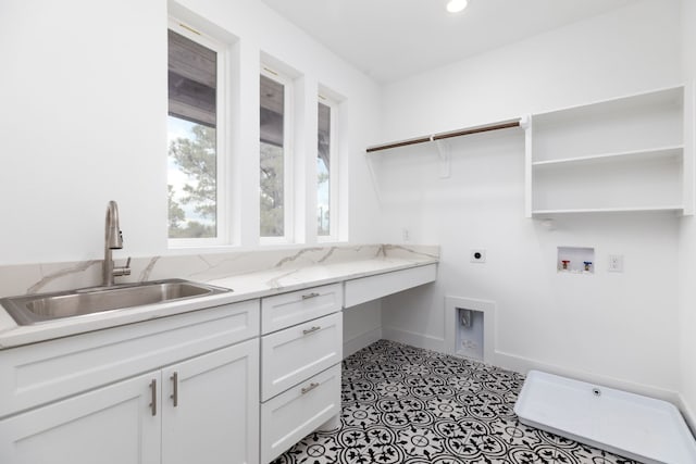 laundry area featuring cabinets, washer hookup, electric dryer hookup, sink, and light tile patterned floors