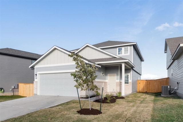 view of front of house with a garage, a front lawn, and central air condition unit