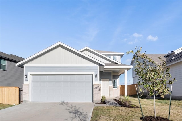 view of front of home featuring a garage and a front yard