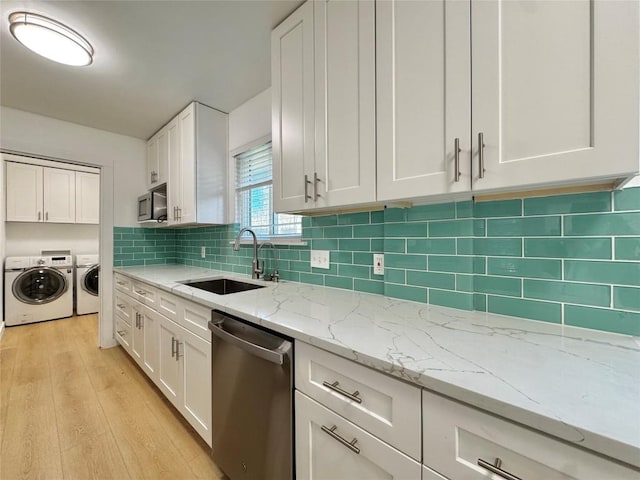 kitchen with dishwasher, white cabinetry, independent washer and dryer, and sink