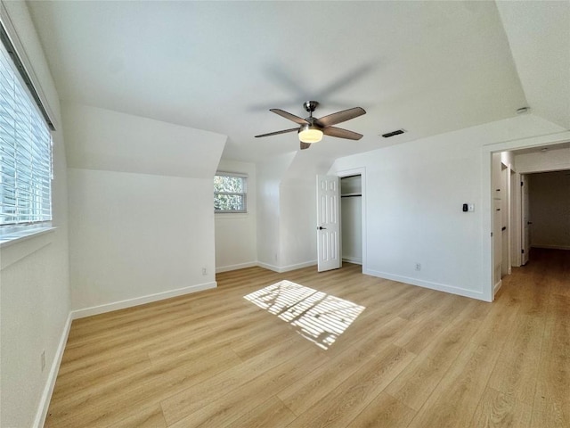 additional living space featuring light wood-type flooring, vaulted ceiling, and ceiling fan