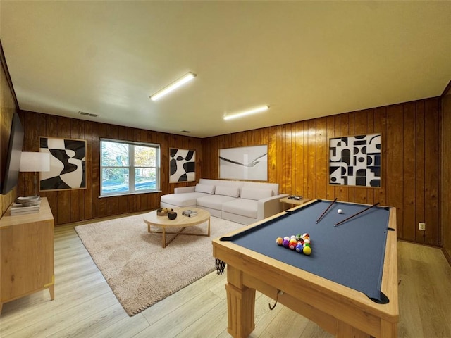 recreation room featuring light hardwood / wood-style flooring, wooden walls, and billiards