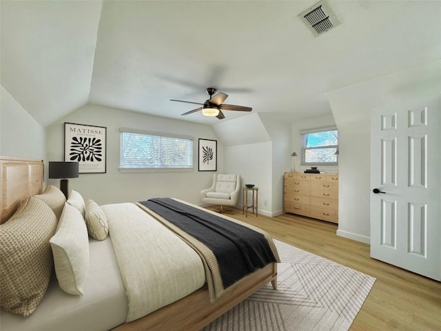 bedroom featuring vaulted ceiling, light hardwood / wood-style flooring, and ceiling fan