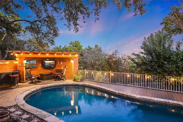 view of pool featuring a pergola and a wooden deck