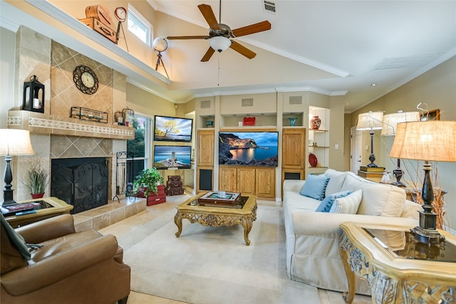 living room featuring ceiling fan, built in features, ornamental molding, and a fireplace