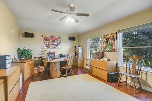 home office with ceiling fan, dark wood-type flooring, and vaulted ceiling