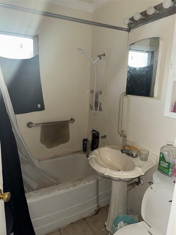 bathroom featuring shower / bath combo with shower curtain, tile patterned flooring, and toilet