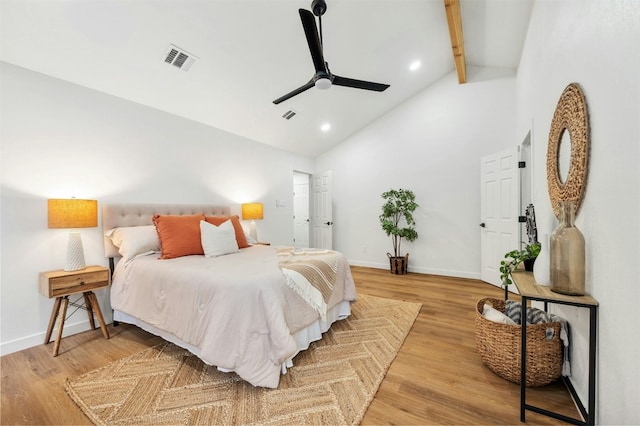 bedroom with ceiling fan, wood-type flooring, beam ceiling, and high vaulted ceiling