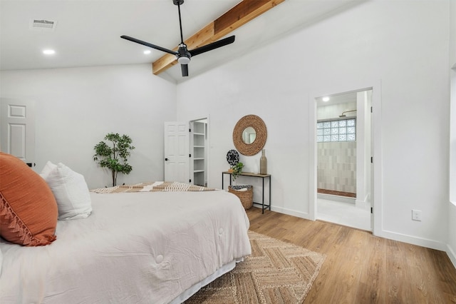 bedroom with connected bathroom, hardwood / wood-style floors, vaulted ceiling with beams, and ceiling fan