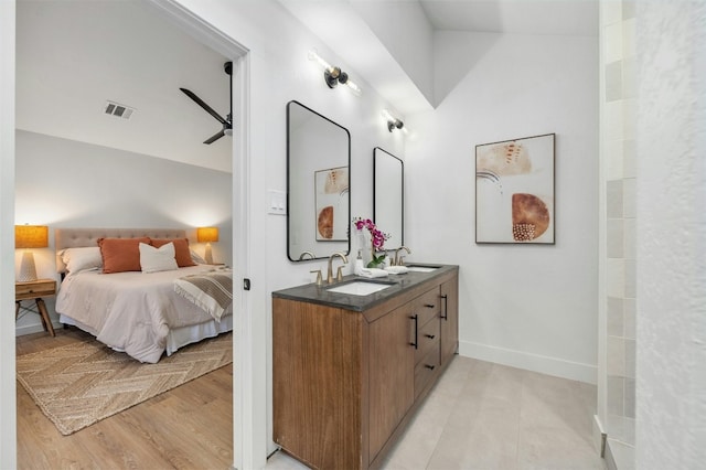 bedroom with sink, ceiling fan, and light wood-type flooring