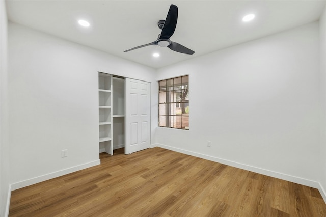 unfurnished bedroom with light hardwood / wood-style floors, a closet, and ceiling fan