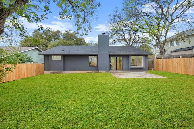 back of property featuring a lawn and a patio