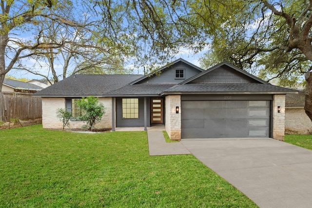 view of front of property featuring a garage and a front lawn