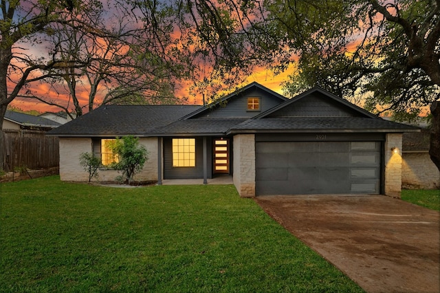 view of front facade with a yard and a garage