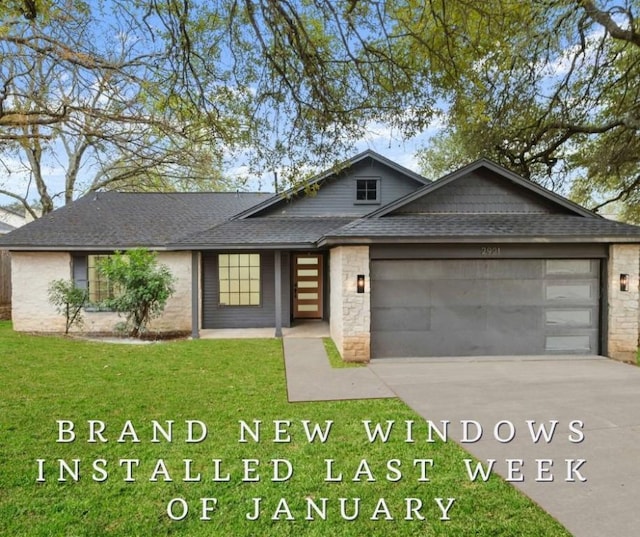 view of front facade with a garage and a front lawn