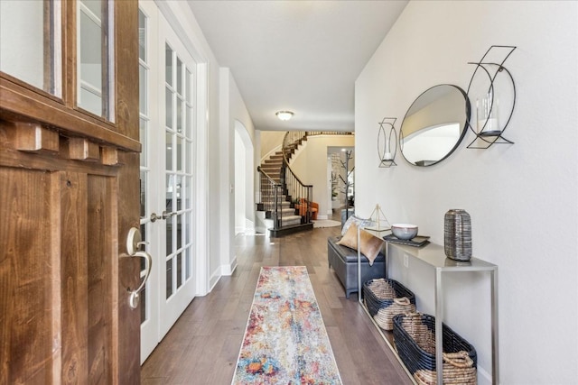 foyer entrance with french doors and dark wood-type flooring