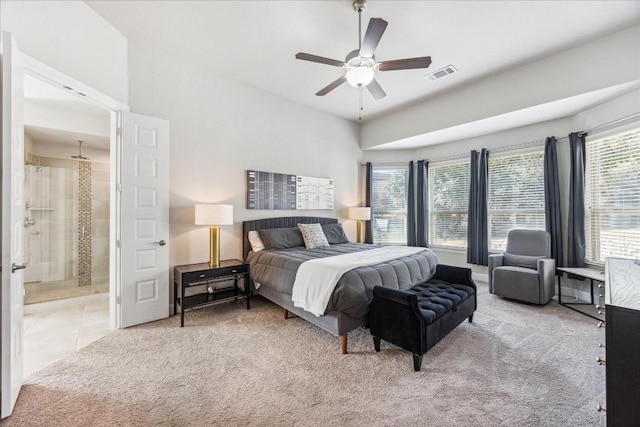 bedroom with carpet, connected bathroom, and ceiling fan