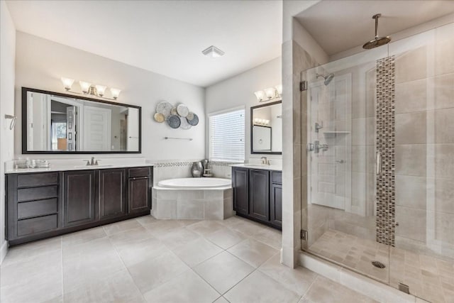 bathroom with tile patterned floors, vanity, and shower with separate bathtub