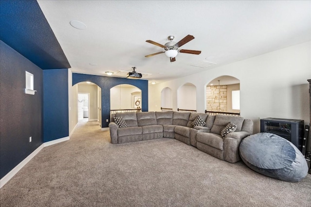 carpeted living room featuring ceiling fan