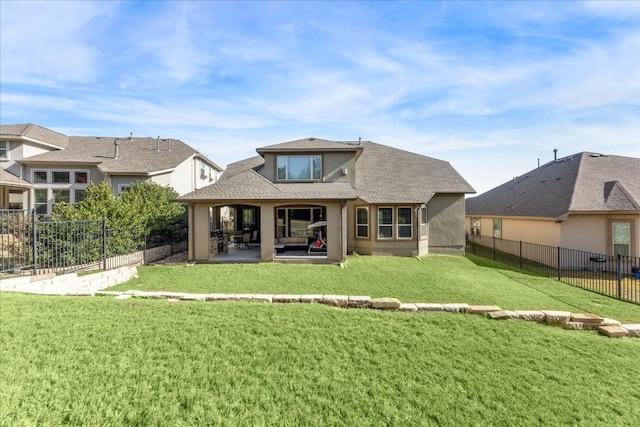 rear view of property featuring a patio and a lawn