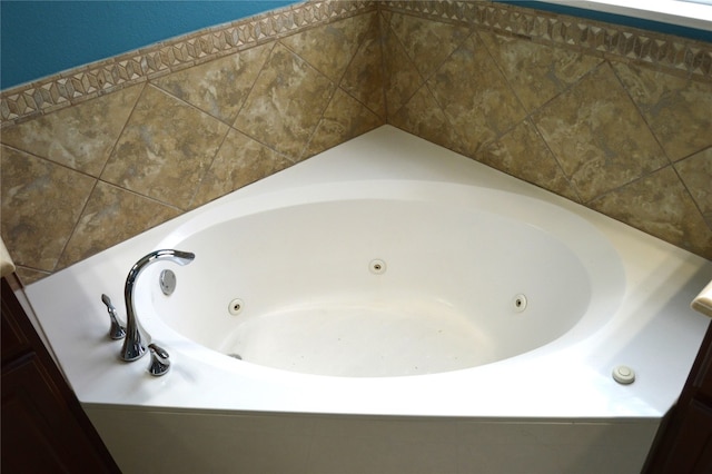 bathroom with a relaxing tiled tub