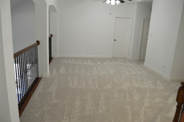 carpeted empty room featuring ceiling fan