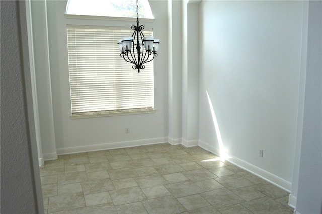 unfurnished dining area with an inviting chandelier