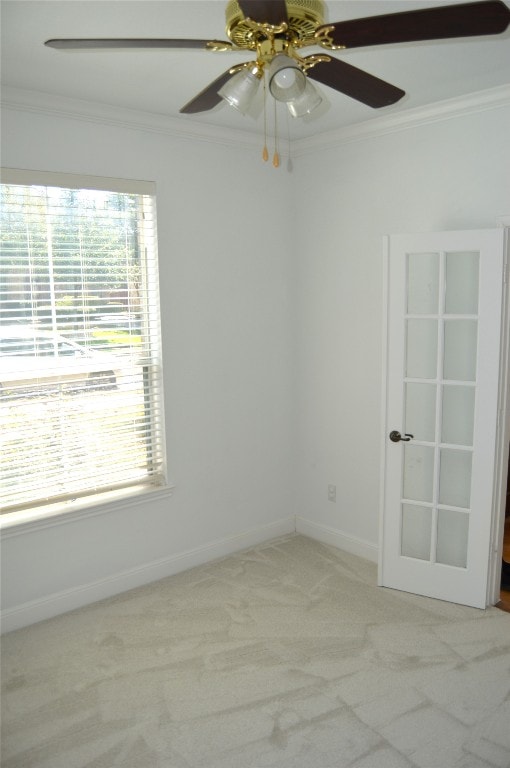 empty room with light carpet, plenty of natural light, and ornamental molding