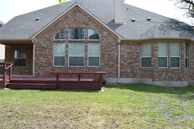 back of house with a lawn and a wooden deck