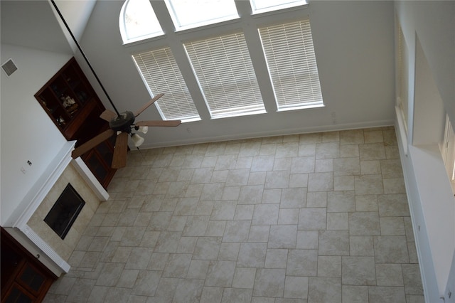 unfurnished living room with ceiling fan