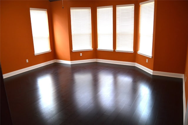 spare room with dark hardwood / wood-style floors