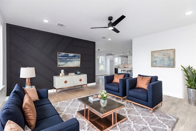 living room featuring ceiling fan and light wood-type flooring