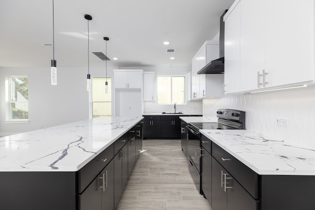 kitchen with black electric range, white cabinets, pendant lighting, and plenty of natural light