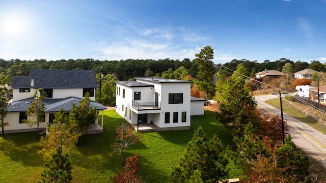 rear view of property with a yard, a patio, and stucco siding