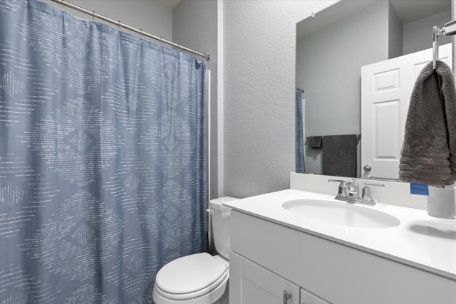 808 Beacon Hts, Seguin, TX 78155 - bathroom with a textured wall, toilet, vanity, and a shower with shower curtain
