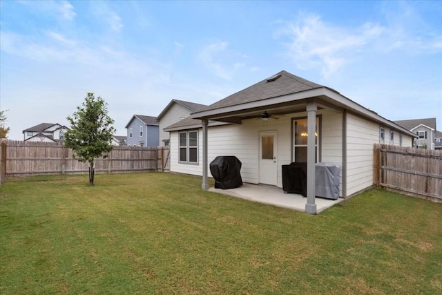 rear view of property featuring a patio, ceiling fan, and a lawn