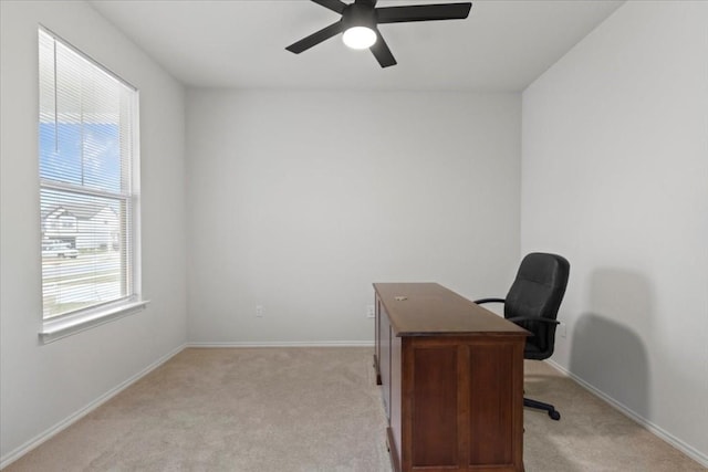 office area with baseboards, light carpet, and ceiling fan