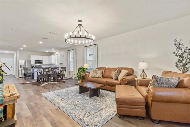 808 Beacon Hts, Seguin, TX 78155 - living room featuring a chandelier, light wood finished floors, and recessed lighting